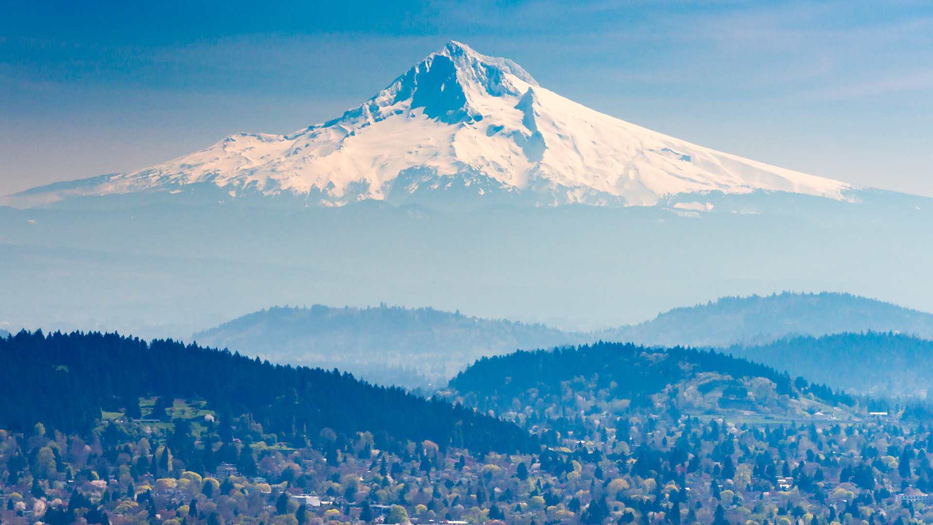 Mount Hood rising beyond Portland neighborhoods as seen from the Pittock Mansion viewpoint.